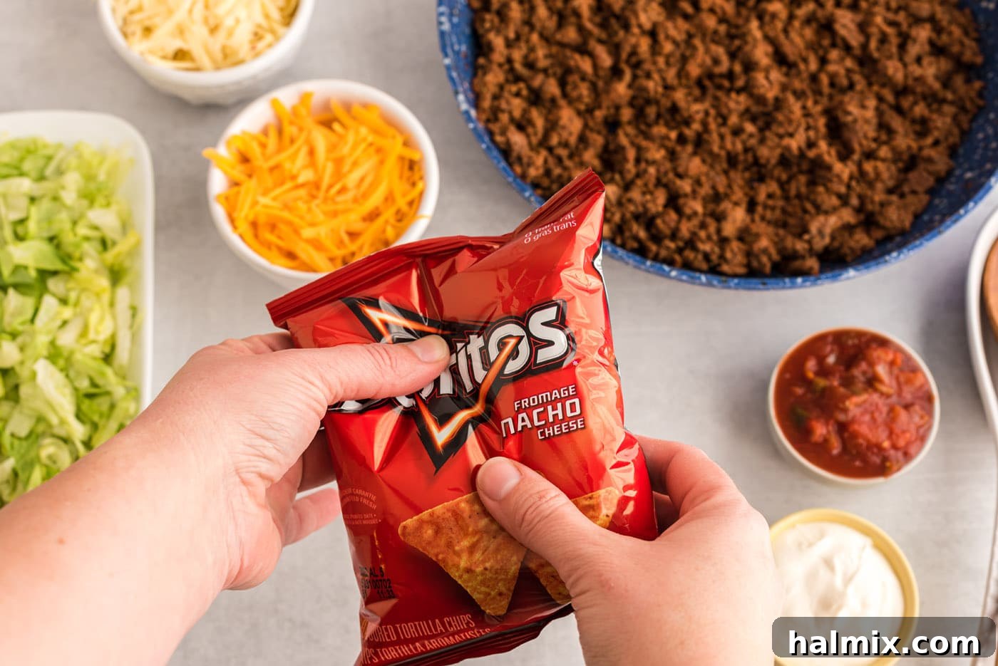 Hand gently crushing a bag of chips