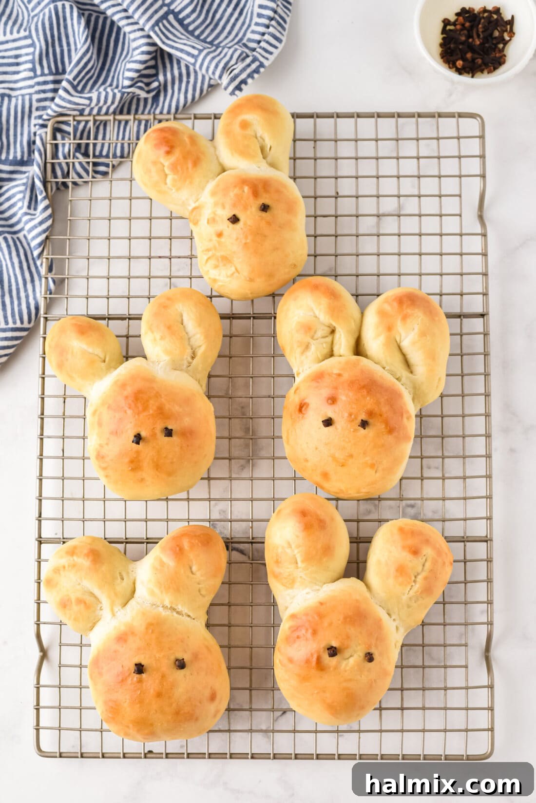 Freshly baked Bunny Rolls cooling on a wire rack, ready for Easter dinner.