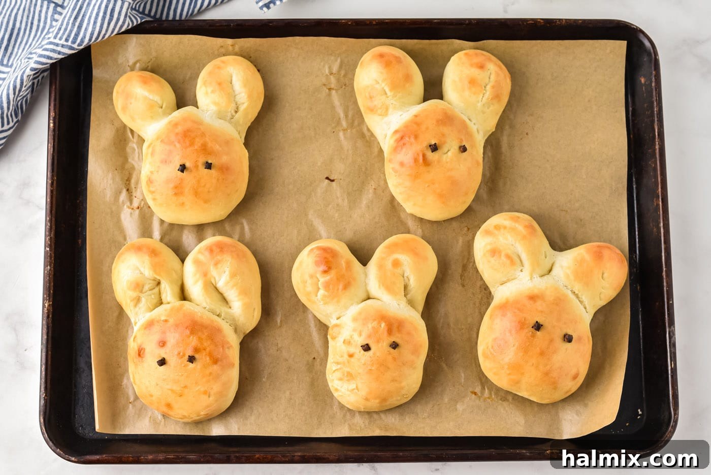 Freshly baked golden brown bunny bread rolls straight out of the oven.