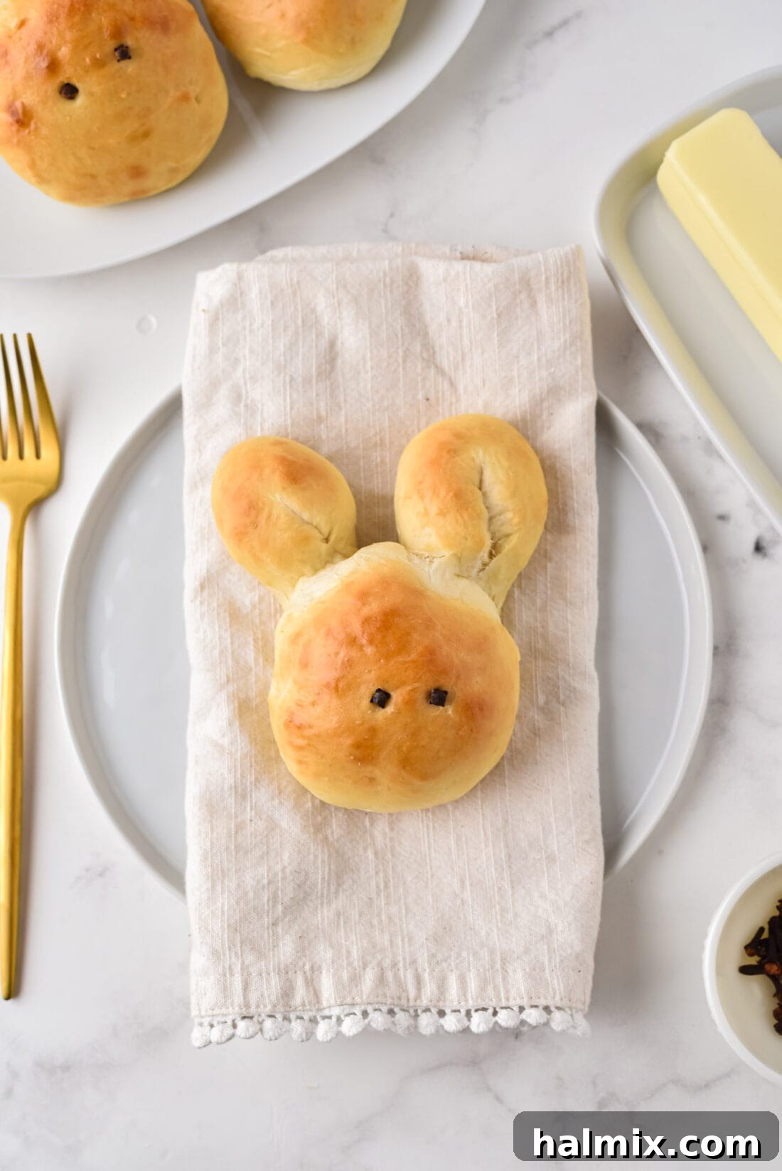 A single bunny roll served on a napkin, acting as a cute place setting for Easter dinner.