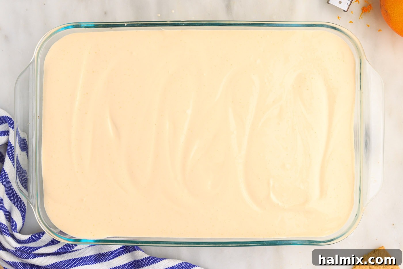 The remaining orange pudding mixture spread over the second layer of graham crackers