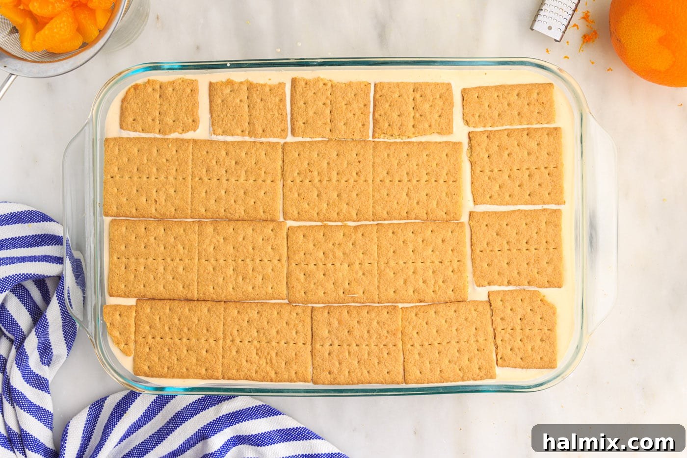 Third layer of graham crackers placed on top of the orange icebox cake