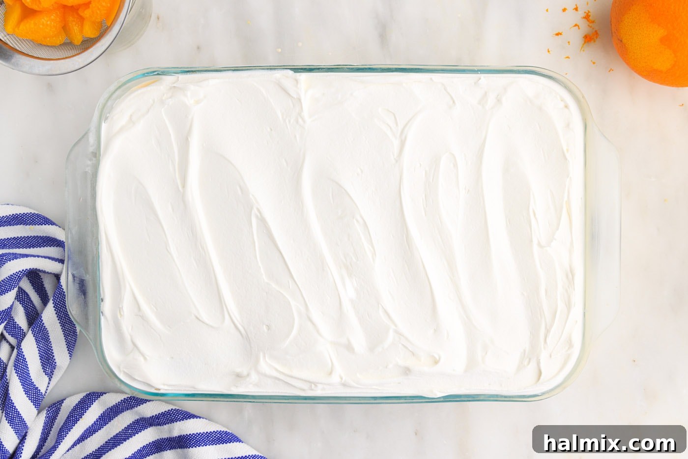 Cool Whip smoothly spread on top of the orange icebox cake
