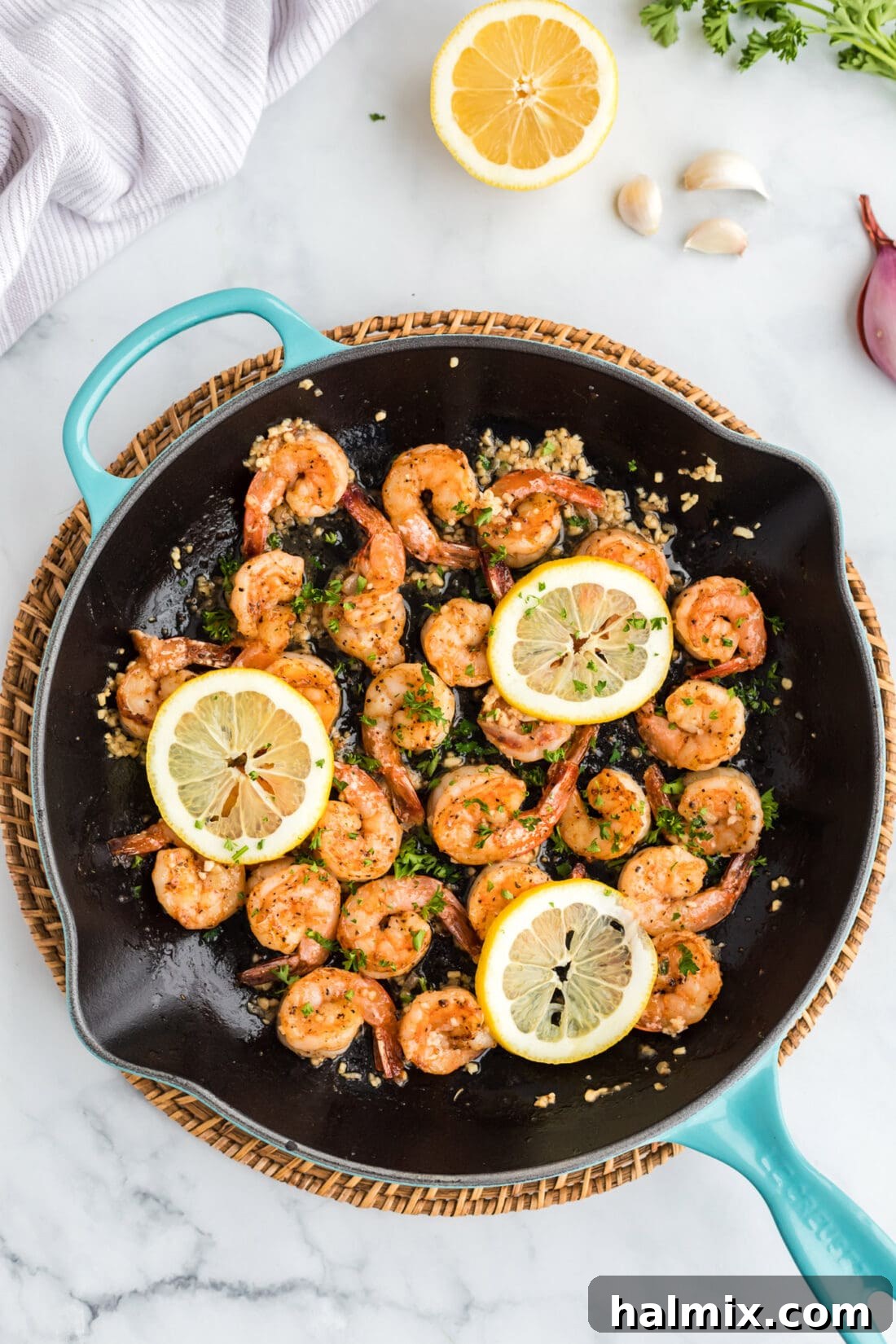Sauteed Shrimp in a skillet, garnished with fresh herbs, ready to serve.