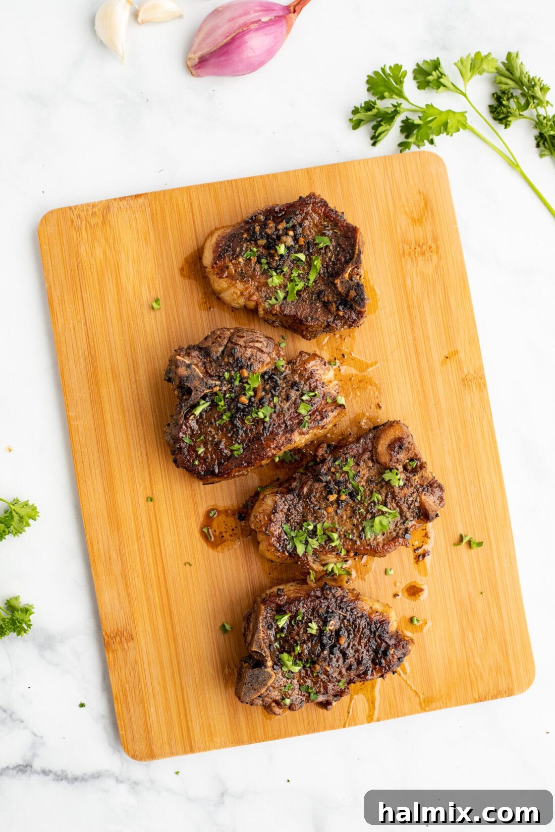 Perfectly seared lamb chops on a cutting board, ready to be served, showcasing their golden-brown crust and succulent interior.
