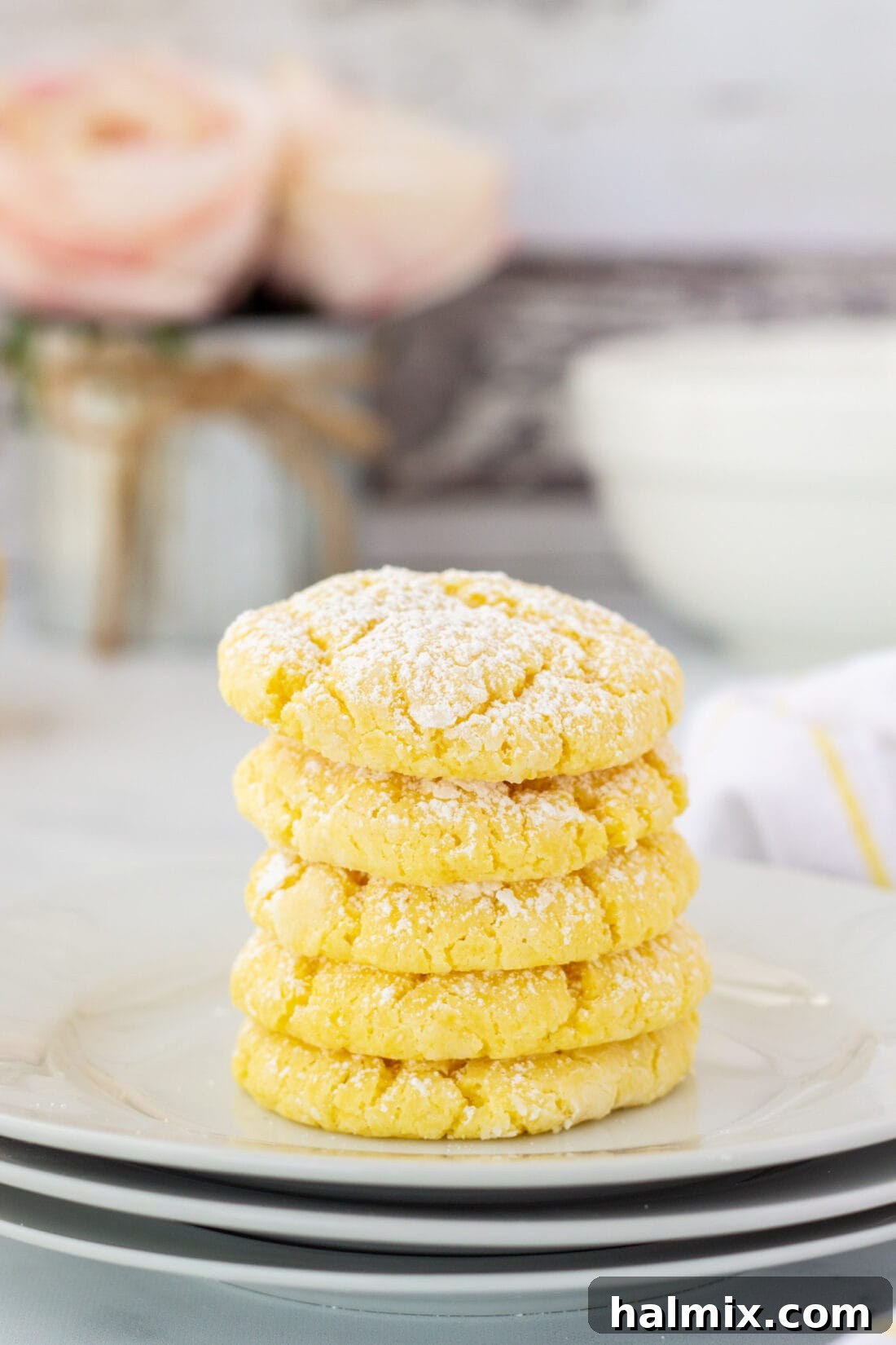 Zesty Lemon Cake Mix Cookies 2 A charming stack of freshly baked Lemon Cake Mix Cookies, showcasing their soft texture and powdered sugar dusting.