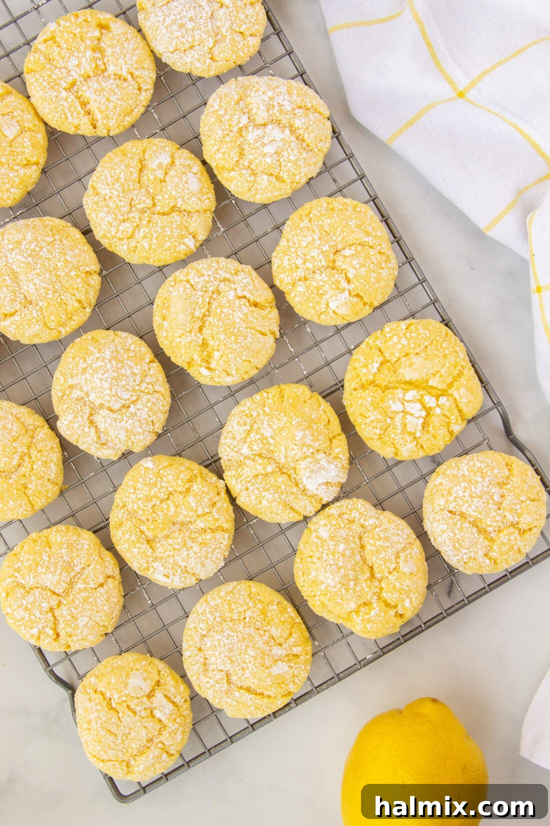 Zesty Lemon Cake Mix Cookies 3 Freshly baked Lemon Cake Mix Cookies cooling on a wire rack, ready to be enjoyed.