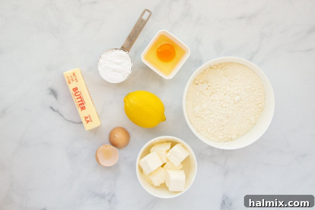 Zesty Lemon Cake Mix Cookies 4 All the simple ingredients laid out for making Lemon Cake Mix Cookies: a box of lemon cake mix, butter, cream cheese, an egg, lemon, and powdered sugar.