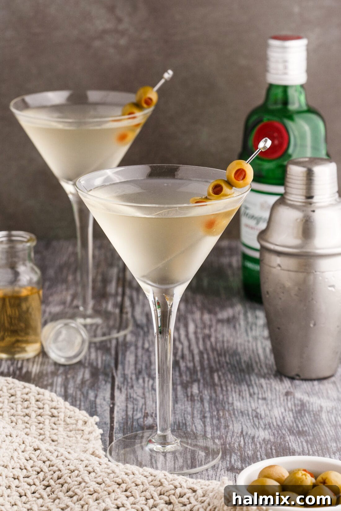 Classic Dirty Martini with elegant liquor bottles in the background