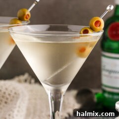 Dirty Martini cocktail in a martini glass with olives