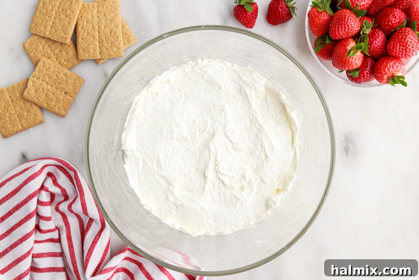 Strawberry Lasagna Delight 14 A creamy layer of cheesecake mixture spread over the graham cracker crumbs in a trifle bowl.