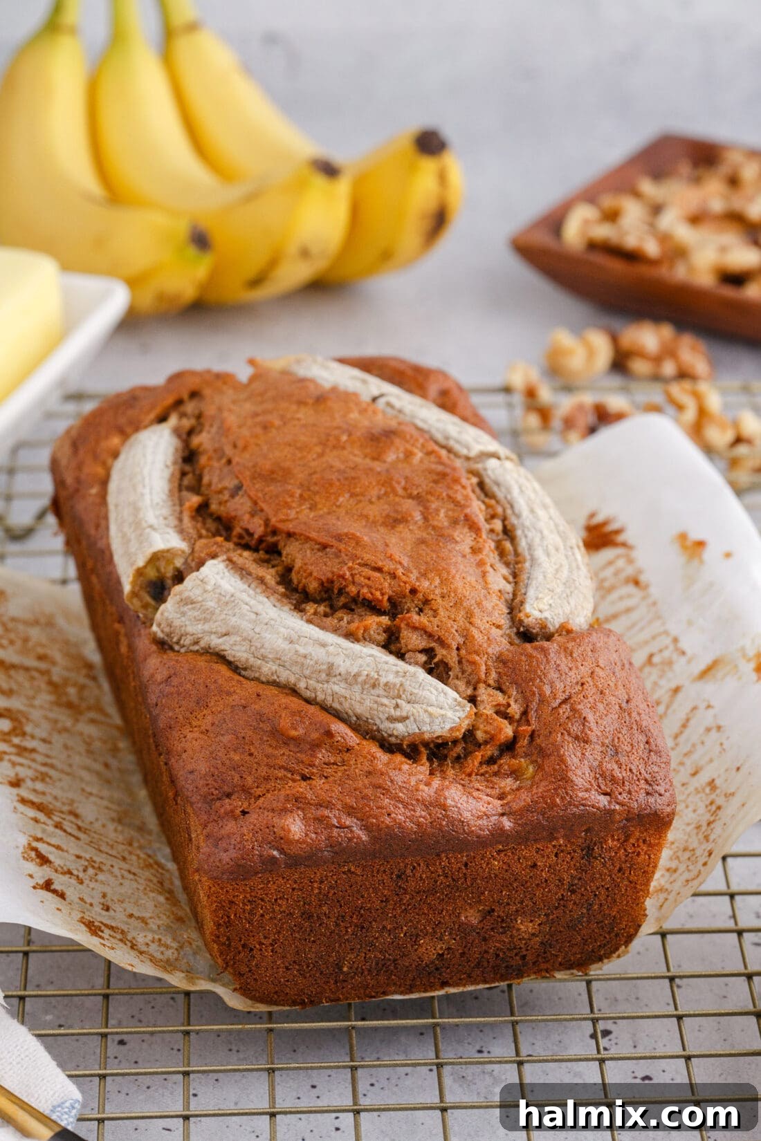 Banana Nut Bread with whole bananas in the background