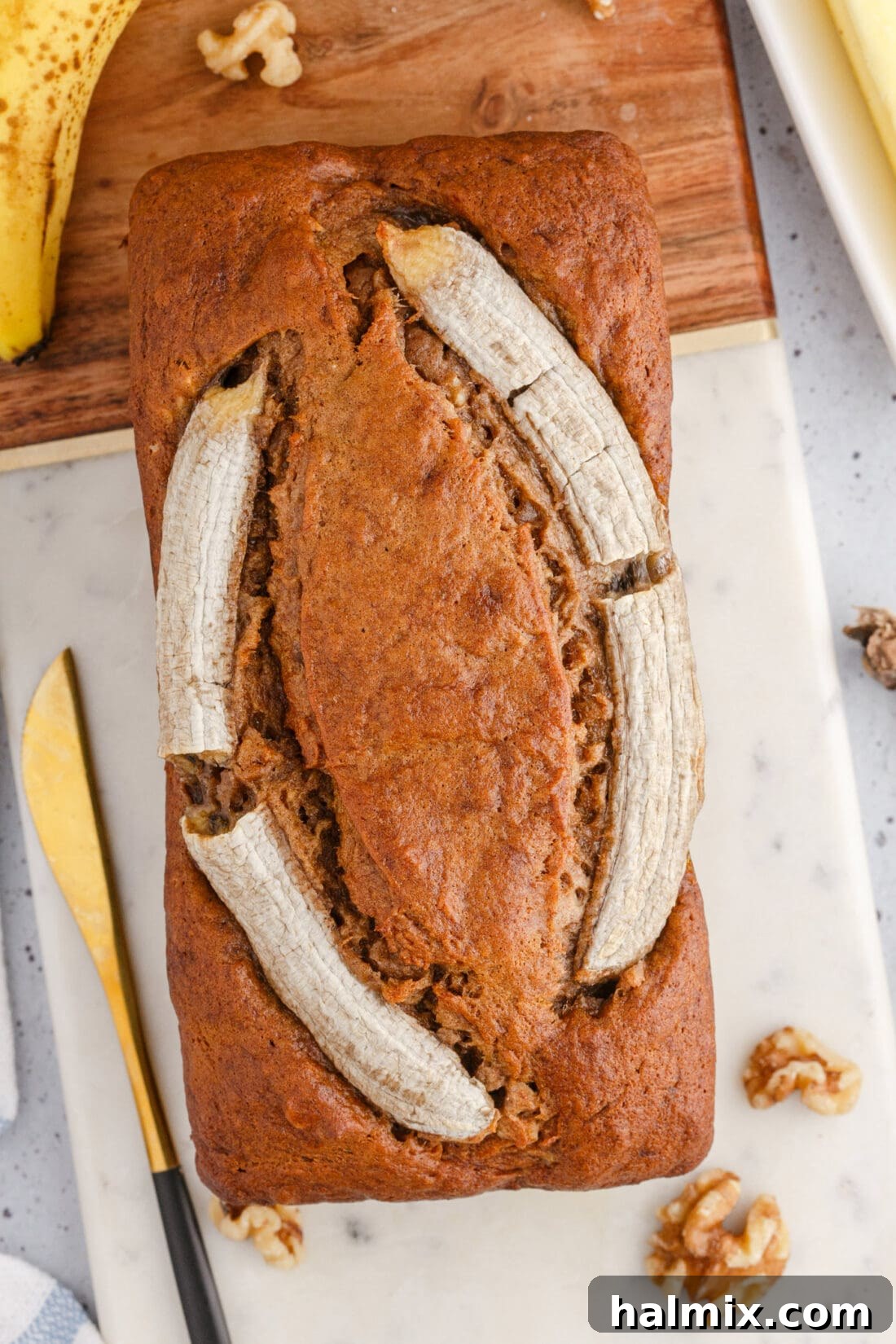 overhead view of Banana Nut Bread with banana garnish, freshly baked