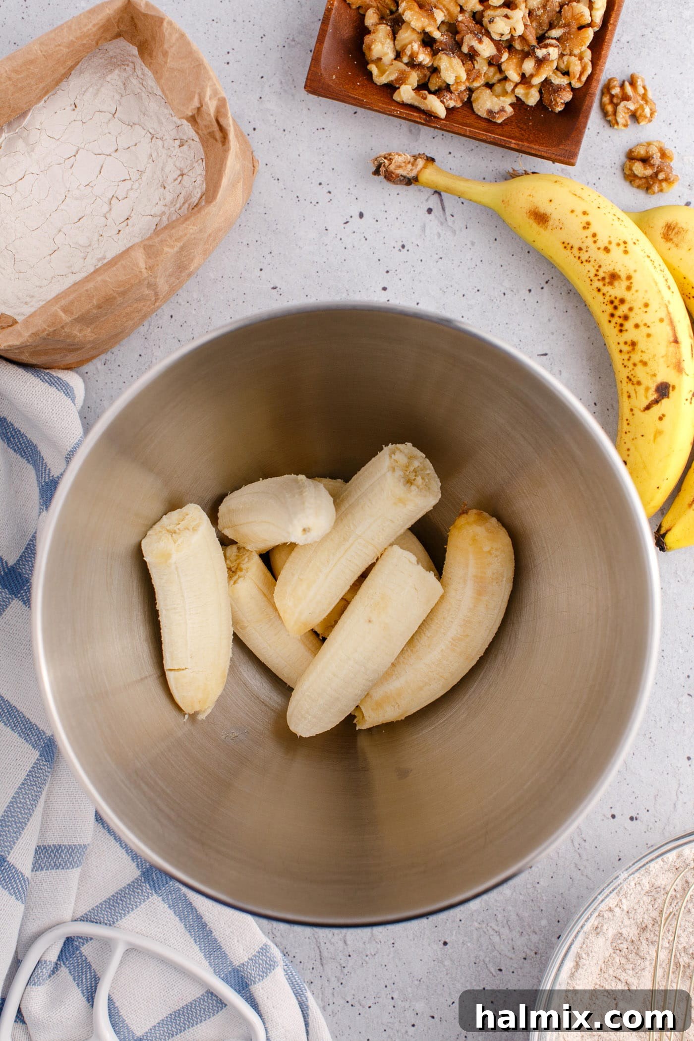 bananas in a mixing bowl being mashed