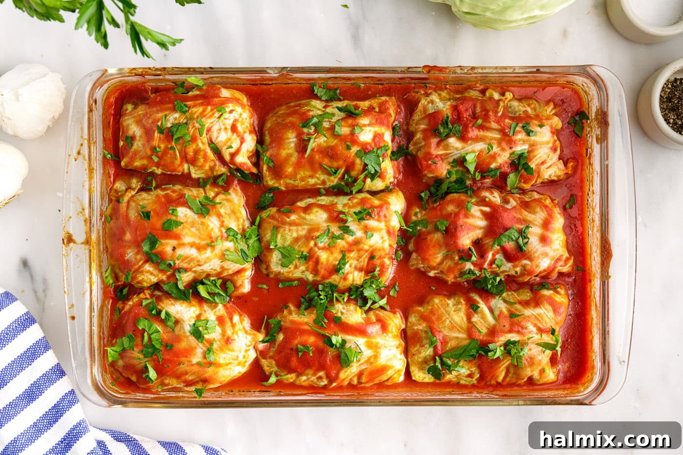 Savory Stuffed Cabbage Bundles 14 A close-up of the freshly baked cabbage rolls, garnished with parsley, in the casserole dish.