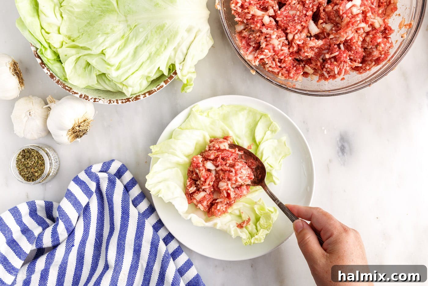 Savory Stuffed Cabbage Bundles 8 Close-up of the process of stuffing cabbage rolls, showing the filling placed on a leaf.