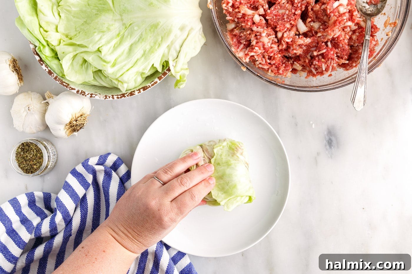 Savory Stuffed Cabbage Bundles 9 Another close-up showing a cabbage leaf being rolled, demonstrating the technique for forming the packet.