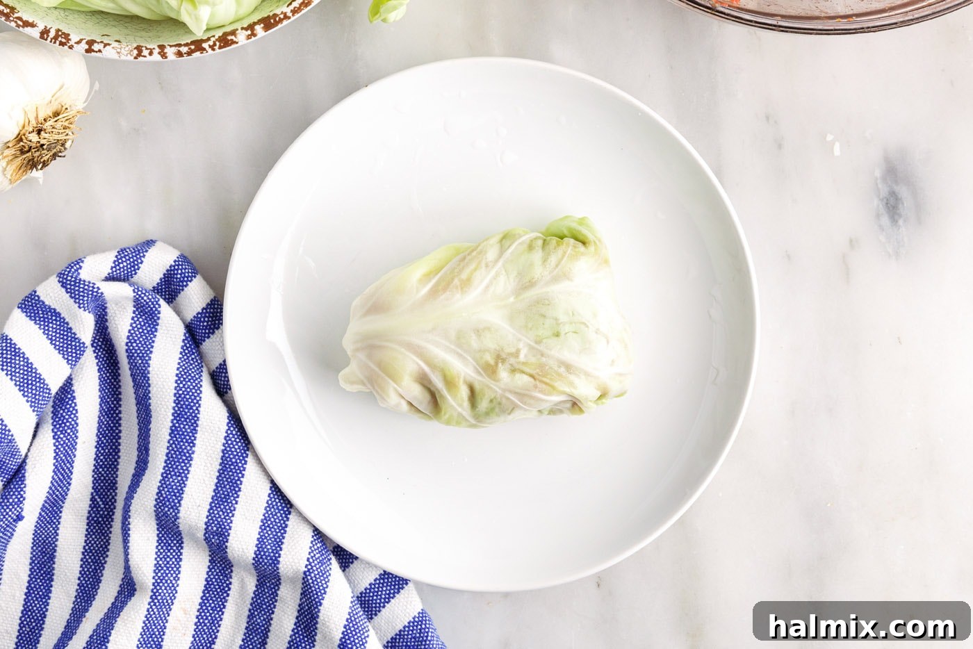 Savory Stuffed Cabbage Bundles 10 A completed cabbage roll, perfectly formed and ready to be placed in the baking dish.