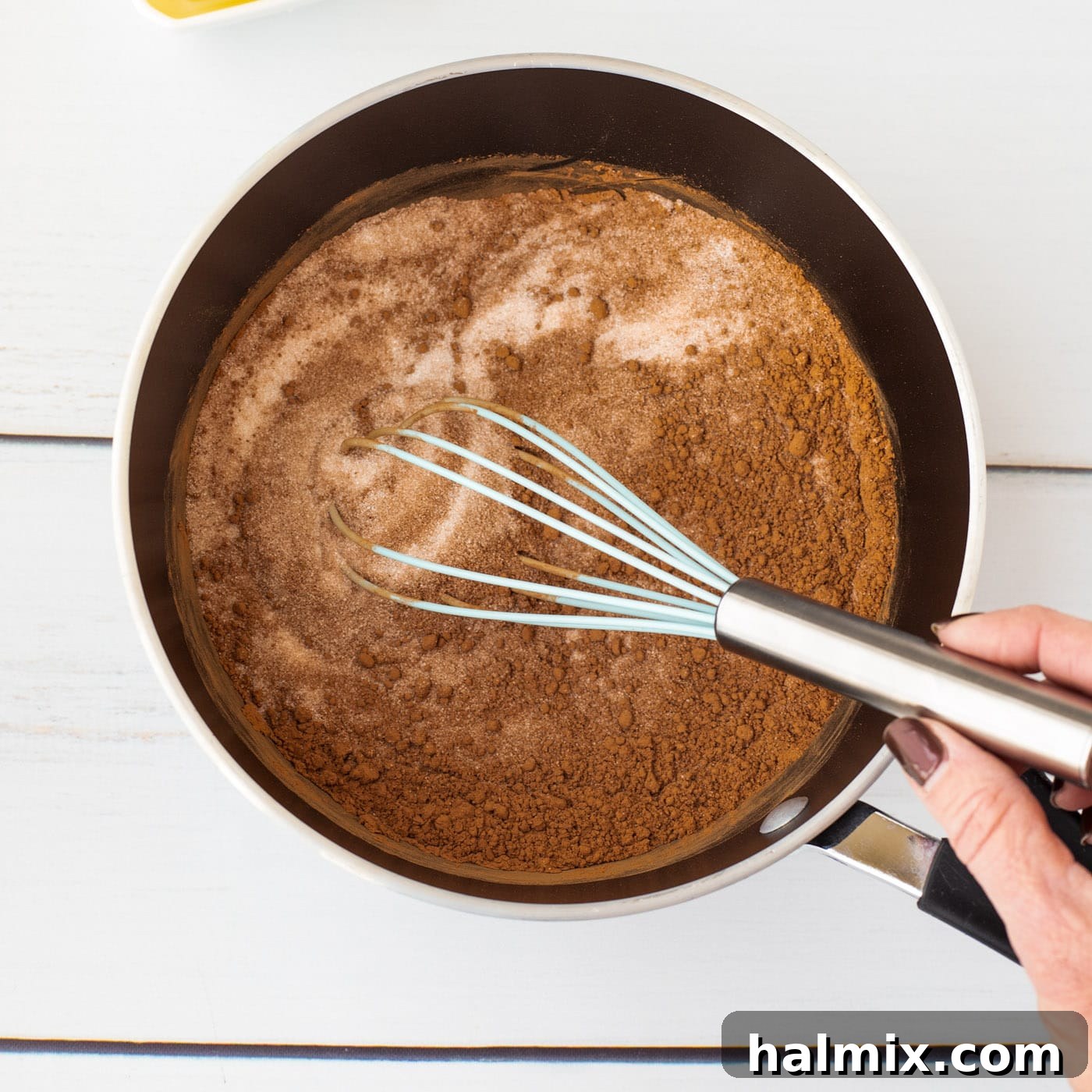 whisking together sugar and cocoa powder