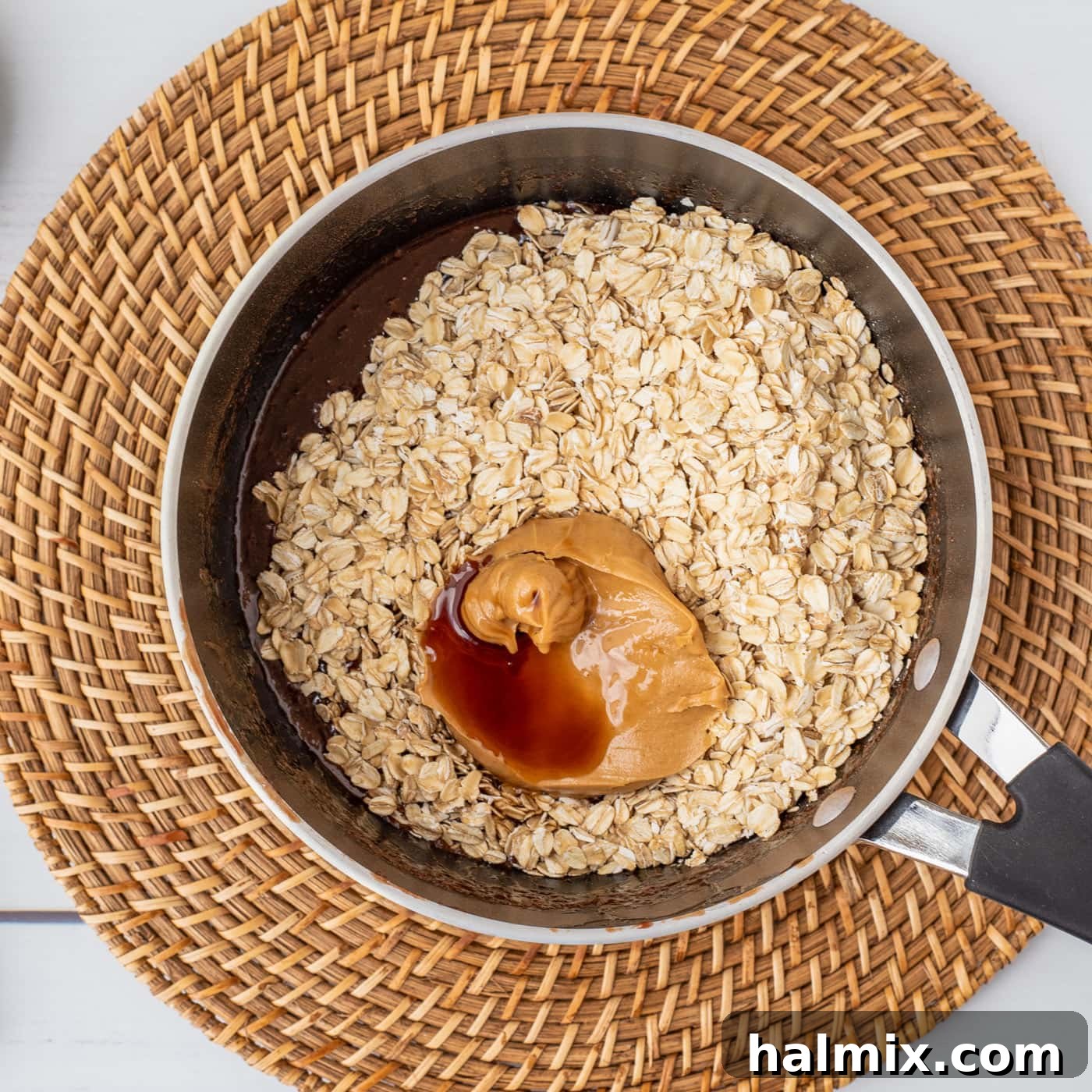 oats, peanut butter, and vanilla over the top of chocolate mixture