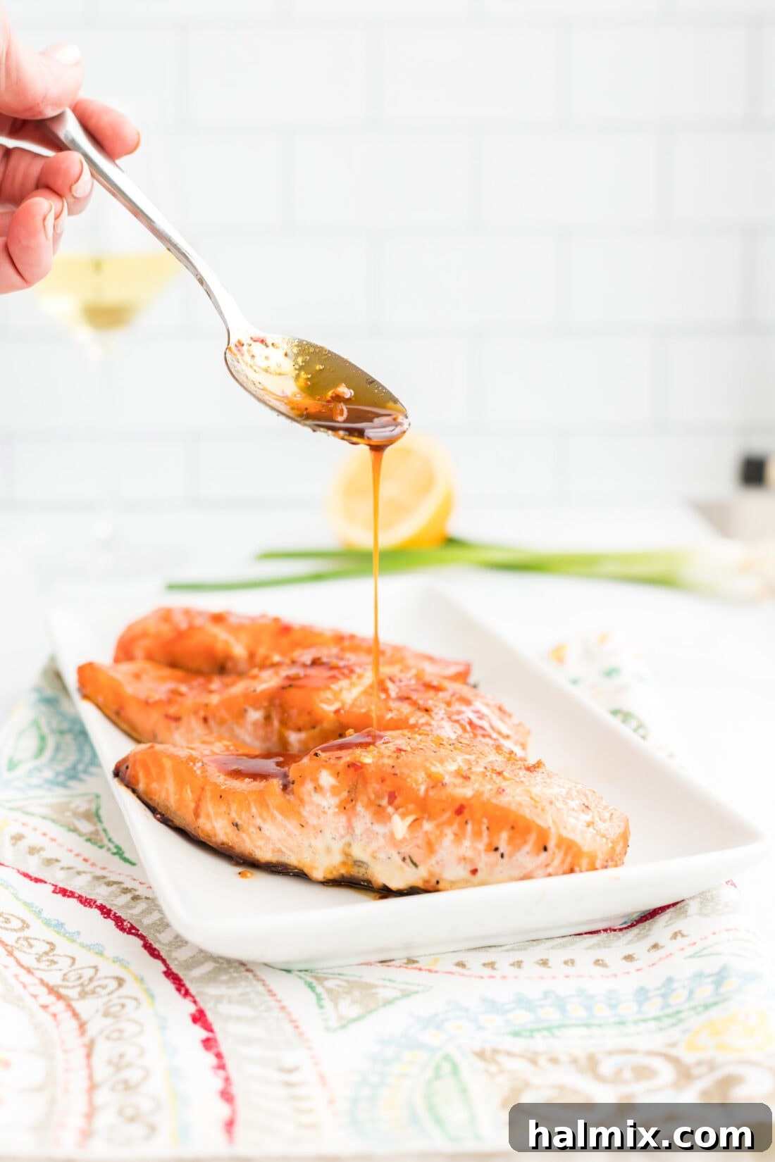 Maple Soy Glazed Salmon 2 Delicious Maple Soy Salmon being drizzled with sauce, ready to serve.