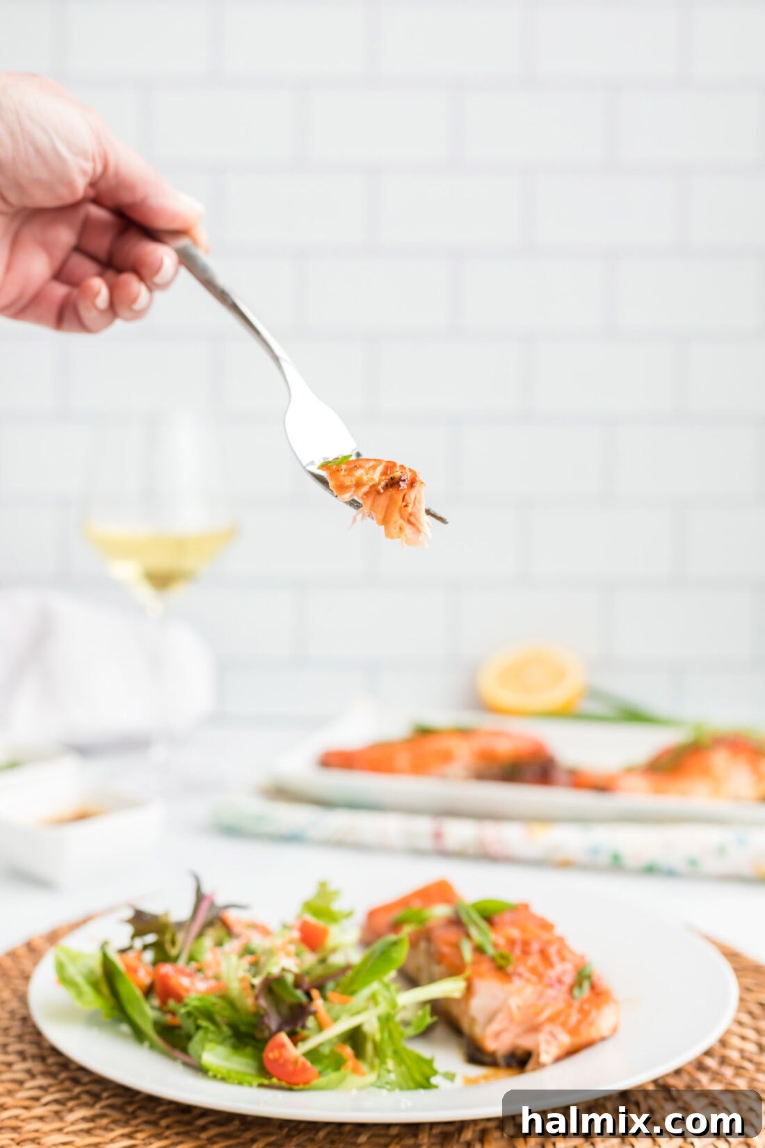 Maple Soy Glazed Salmon 8 A fork lifts a perfectly cooked piece of Maple Soy Salmon, showing its flakiness.