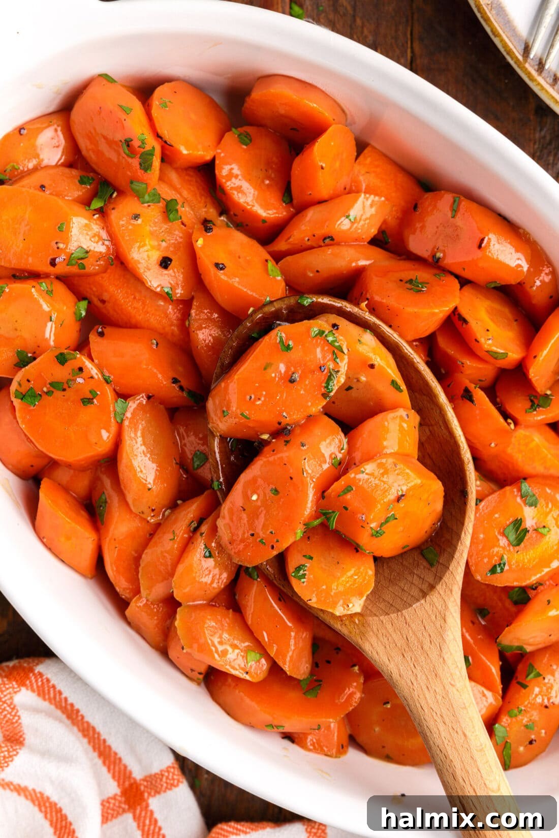 wooden spoon lifting Glazed Carrots