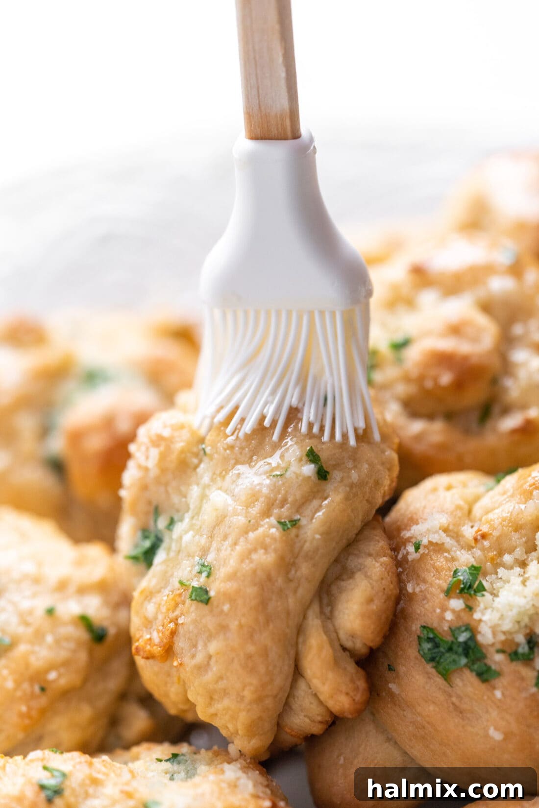 brushing butter on garlic knots