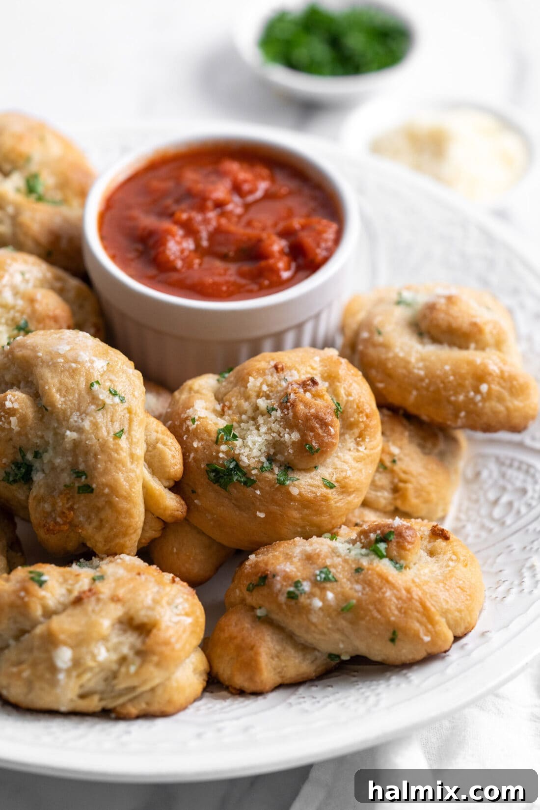 garlic knots on a plate with marinara