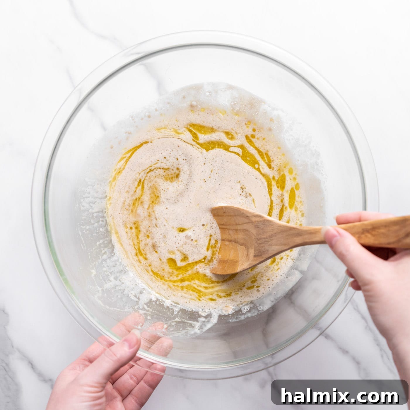 mixing ingredients into yeast in a bowl
