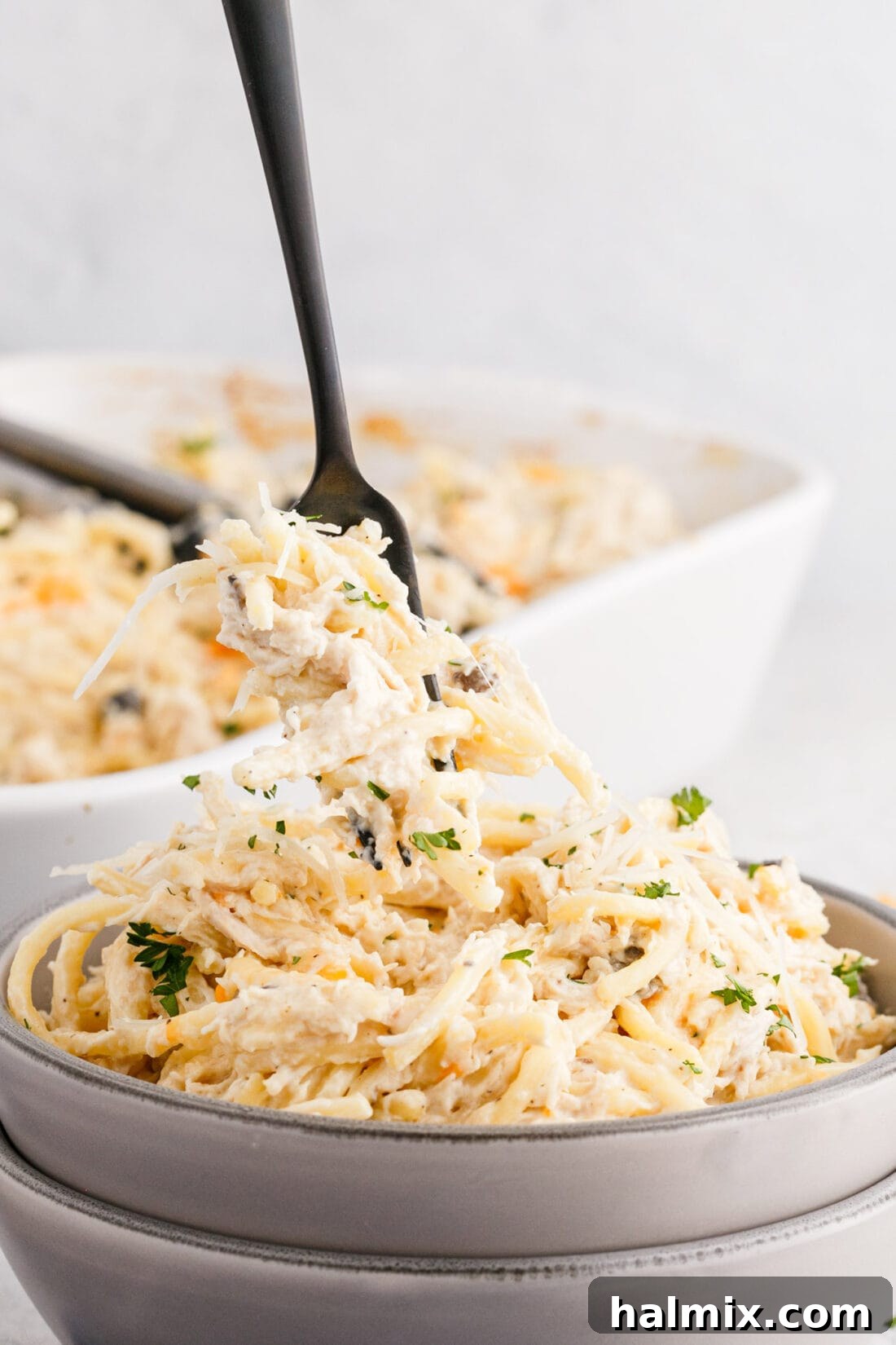 Creamy Baked Chicken Tetrazzini 10 fork lifting Chicken Tetrazzini