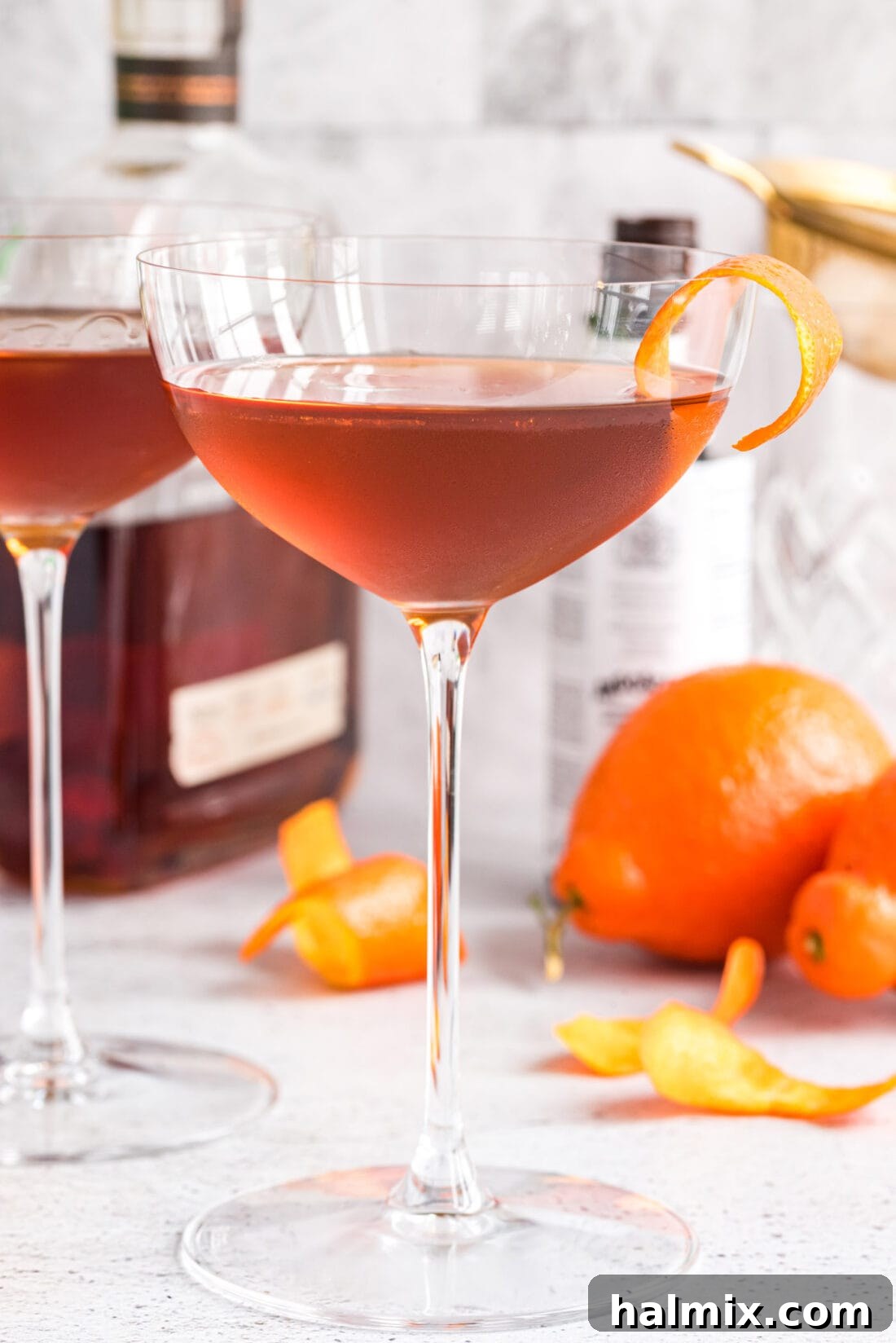 Manhattan Cocktail with liquor bottles in background