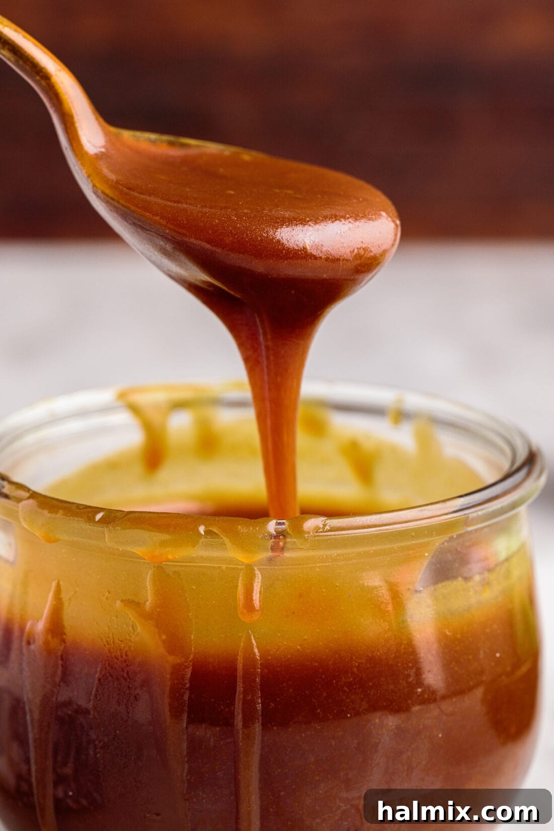Spooning out some Caramel Sauce from a jar