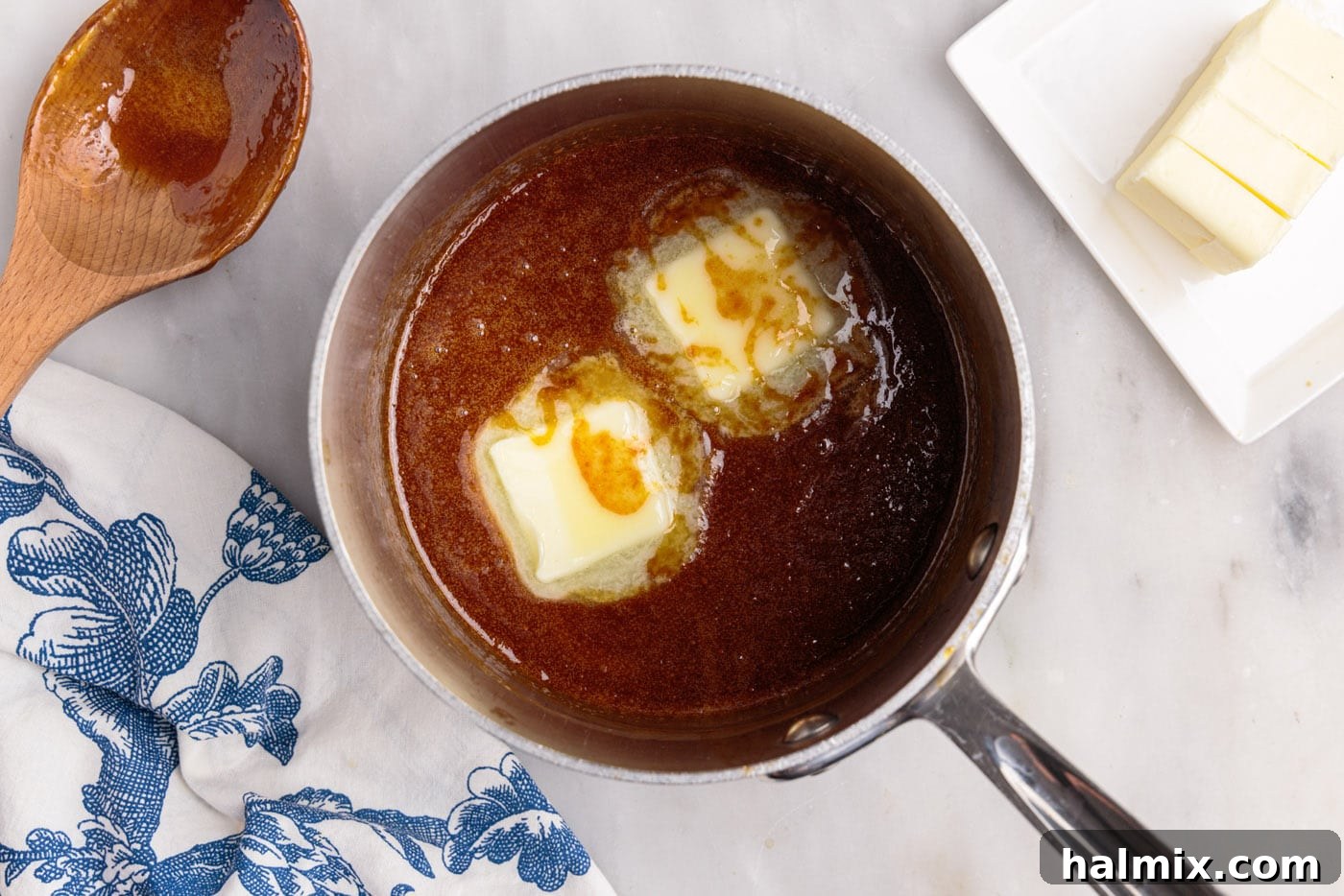 adding butter to caramel sauce