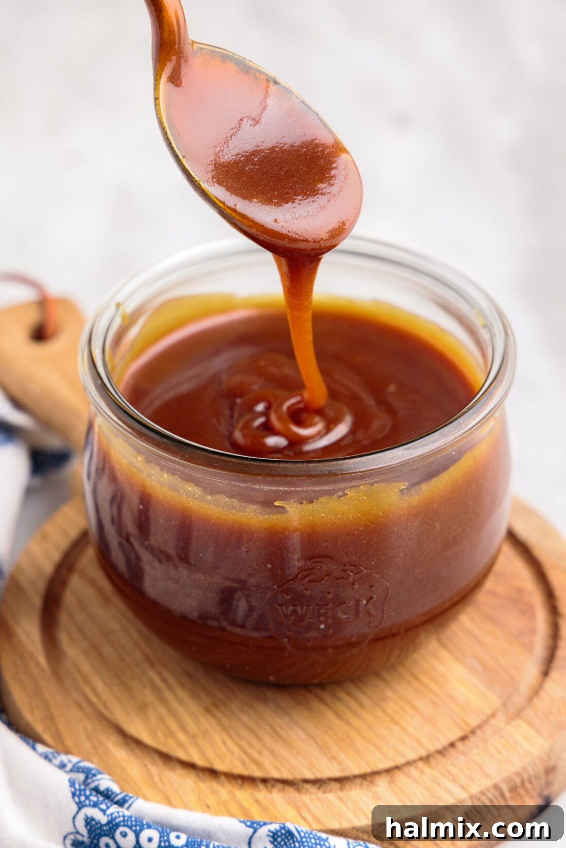 spoon in jar of Caramel Sauce