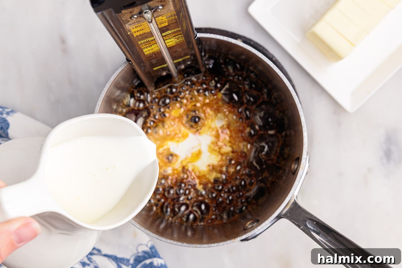 heavy cream pouring into caramel sauce