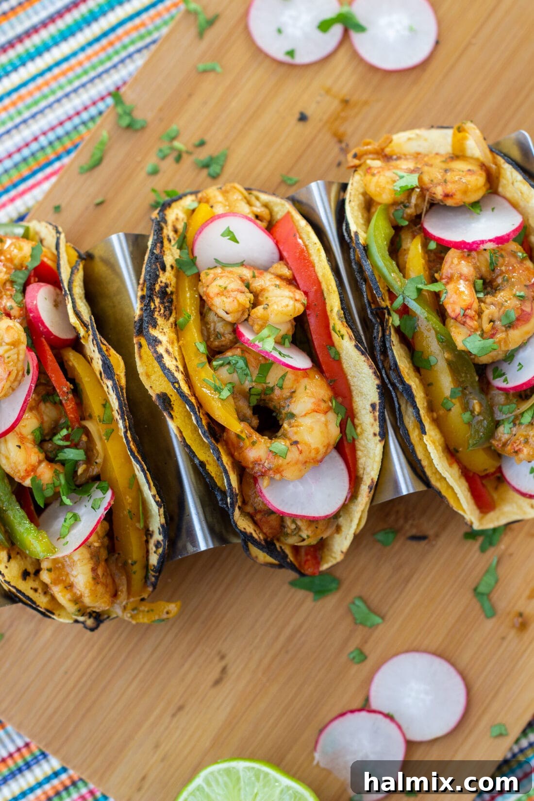 Close-up of freshly assembled Shrimp Fajitas in warm tortillas with cilantro and lime