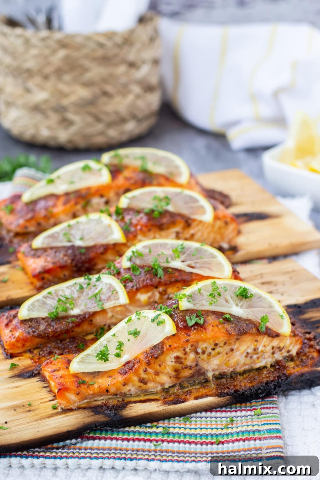 Flavorful Cedar Plank Salmon garnished with fresh lemon slices and herbs.