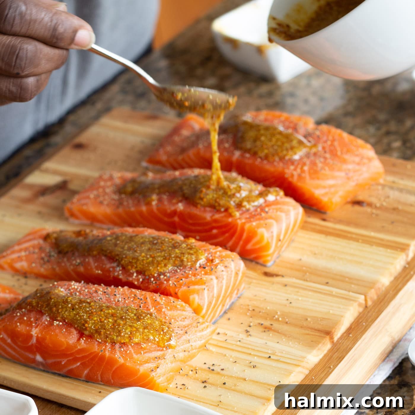 Mixing stone ground mustard, honey, and brown sugar in a bowl for the salmon glaze.