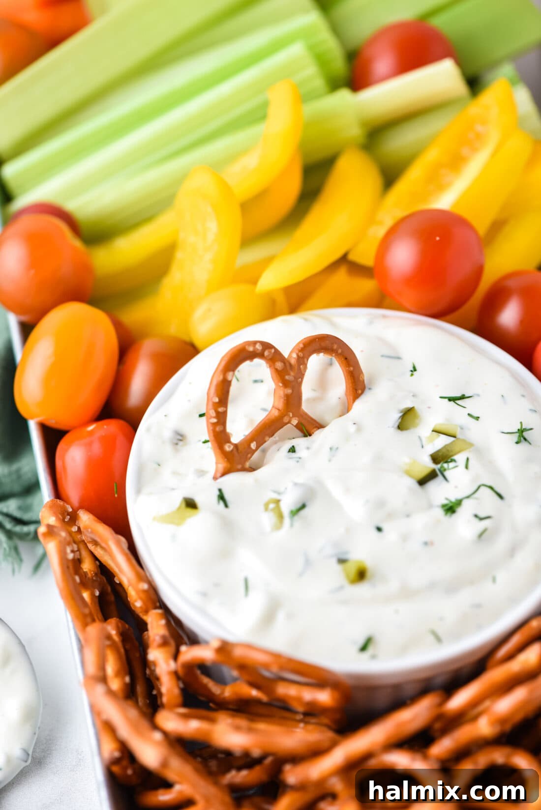 Creamy Dill Pickle Dip served with a pretzel for dipping