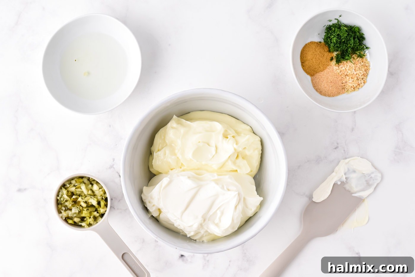 Mayonnaise and sour cream in a mixing bowl