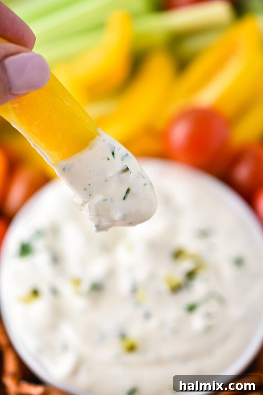 Yellow bell pepper dipped in creamy Dill Pickle Dip
