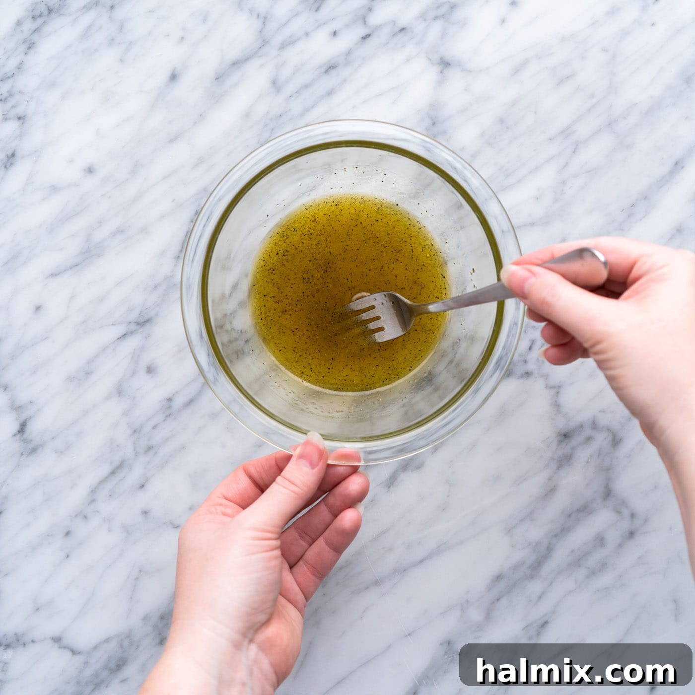 whisking vinaigrette in a small bowl