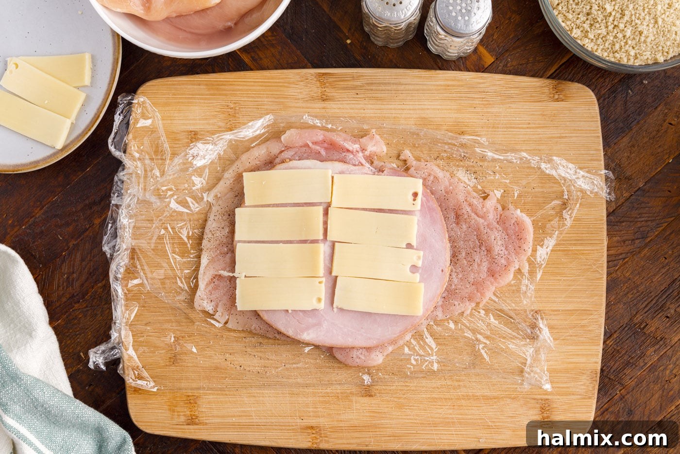 swiss cheese and ham on top of chicken breast
