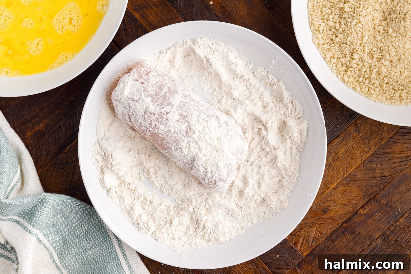 dreding rolled chicken in flour