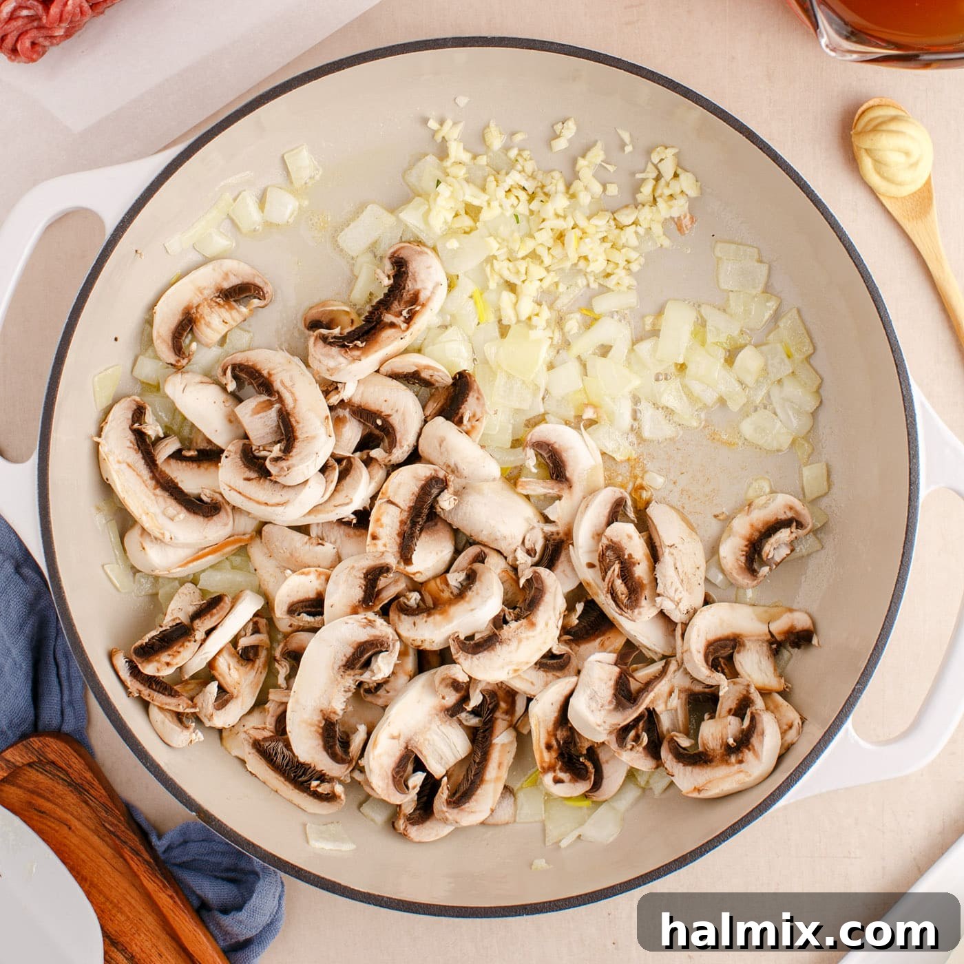 Creamy Ground Beef Stroganoff 6 Sautéing sliced mushrooms and minced garlic with onions in butter until soft and fragrant.