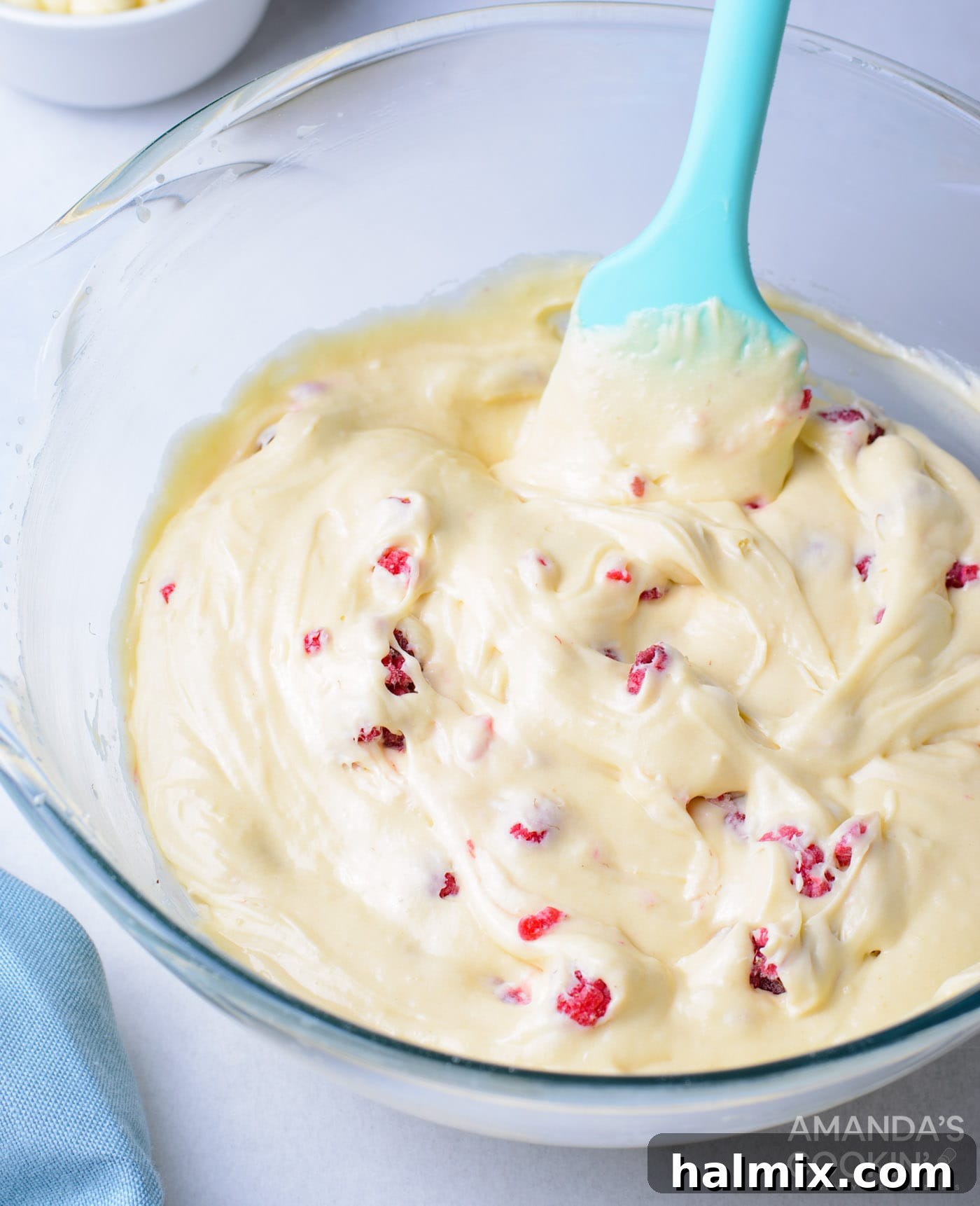 Cupcake batter with fresh raspberries gently folded in, ready for baking