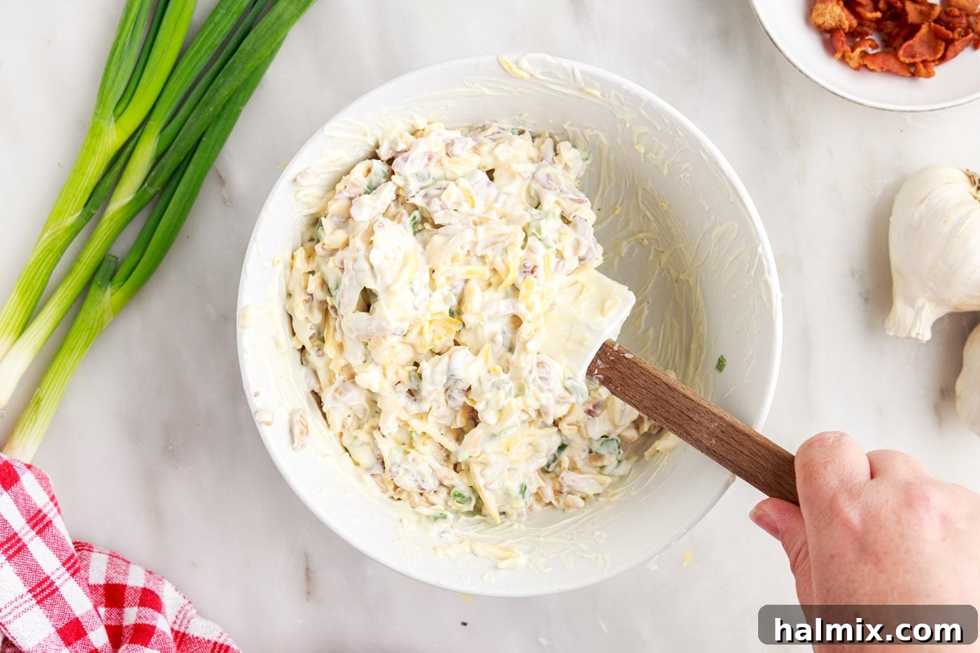 mixing million dollar dip in a bowl