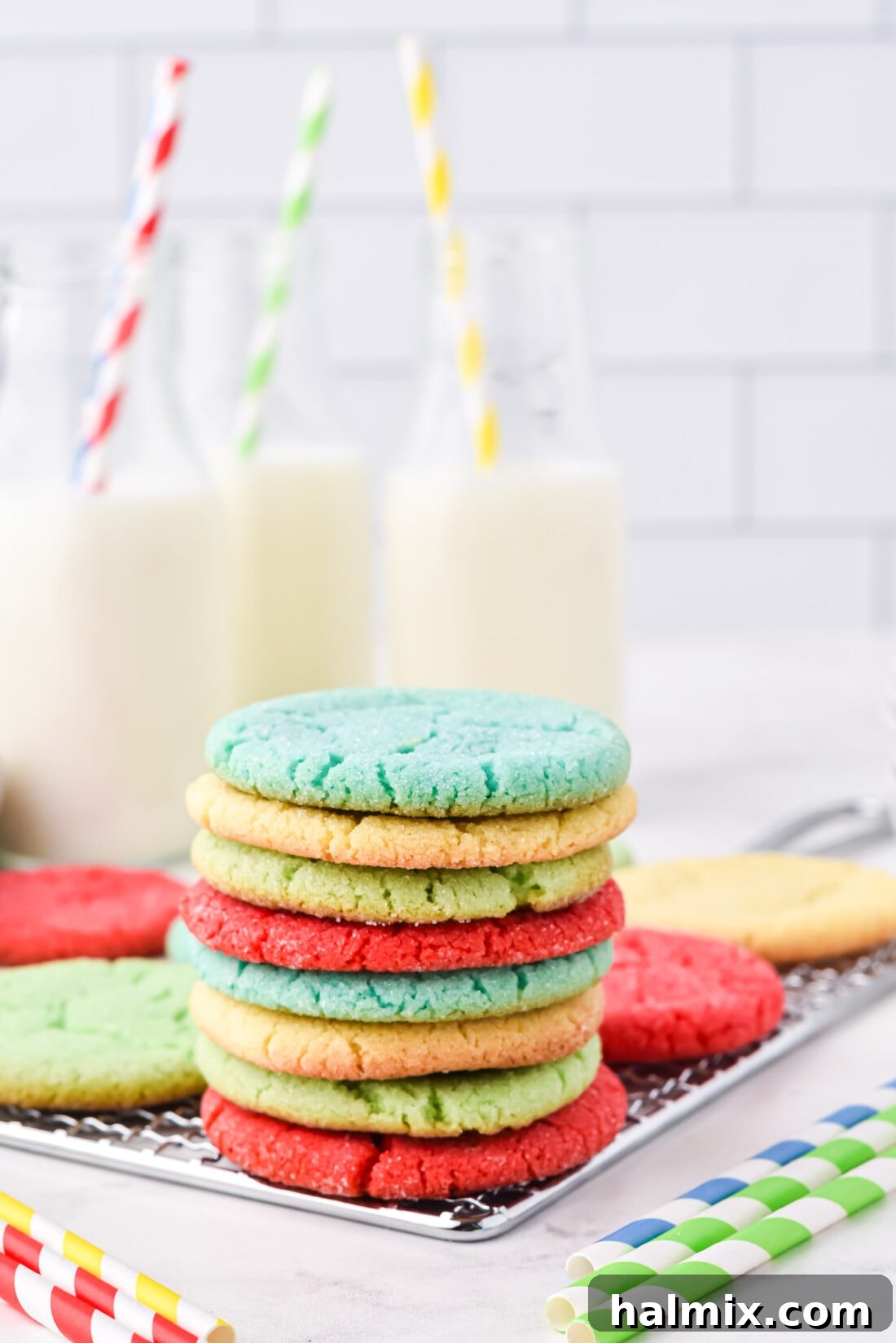 stack of Jello Cookies with milk, showcasing a variety of vibrant colors