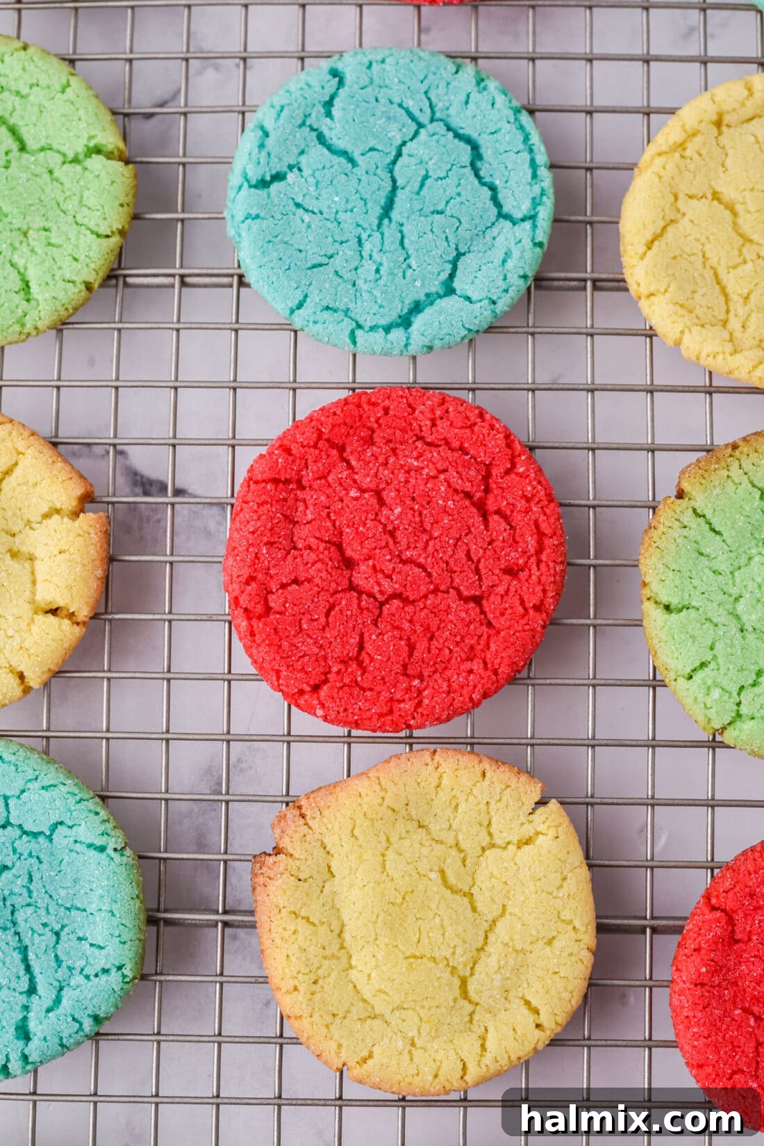 Freshly baked Jello Cookies cooling on a wire rack, displaying their appealing colors